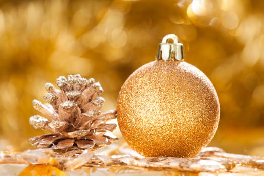 Golden Christmas background with christmas ball and cone