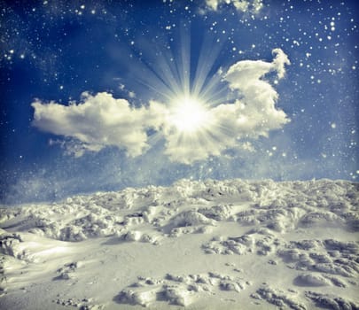 Winter landscape with snow covered hill and cloudy blue sky