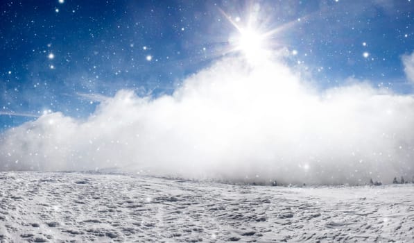 Winter landscape with snow covered hill and cloudy blue sky