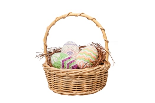 Colorful easter eggs in the nest on wooden basket over white background. Happy Easter
