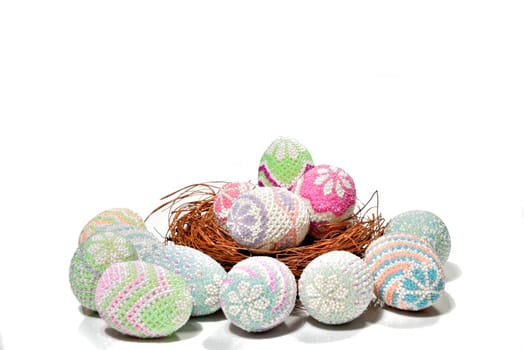 Colorful easter eggs in the nest and floor over white background. Happy Easter