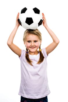 Cute girl playing football, happy child, young female goalkeeper enjoying sport game, holding ball, isolated portrait of a preteen smiling and having fun, kids activities, little footballer