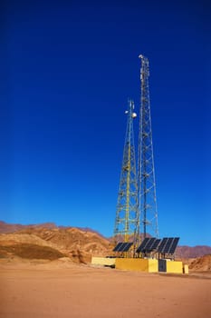 gsm towers with solar panels in the mountains