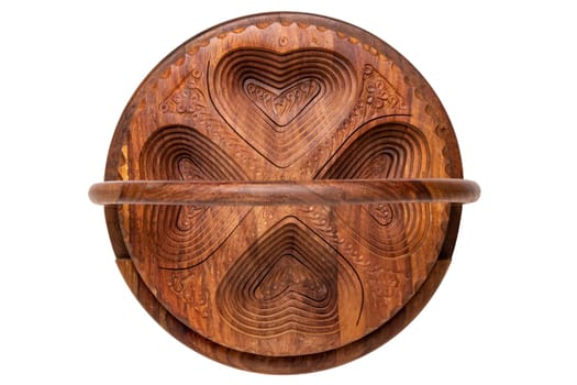 Wooden bowls. Closeup of handmade hinged wooden bowl for fruits, vegetables and nuts isolated on a white background. Decorative souvenir from Malaysia. Top view.