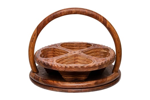 Wooden bowls. Closeup of handmade hinged wooden bowl for fruits, vegetables and nuts isolated on a white background. Decorative souvenir from Malaysia.
