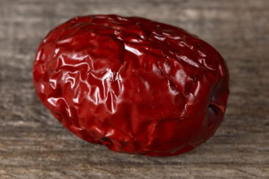 Chinese red date dates closeup on wooden background