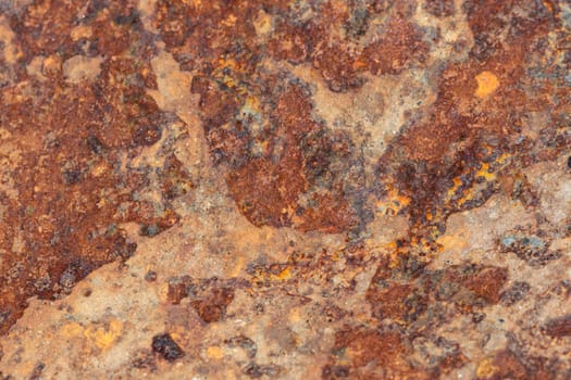 Brown tin wall with rust and peeled paint as a background