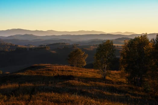 Beauty sunset in the mountains in Altay, panoramic picture. Autumn photo.