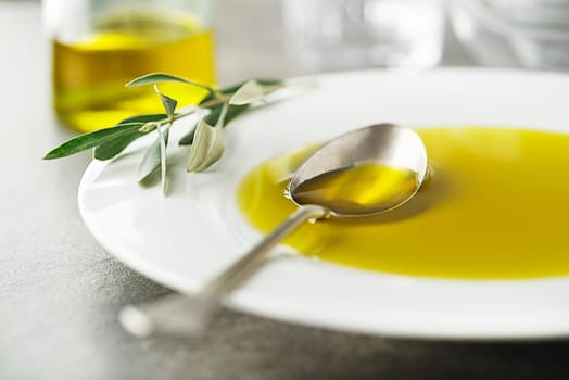 Healthy olive oil pouring with spoon close up-image concept