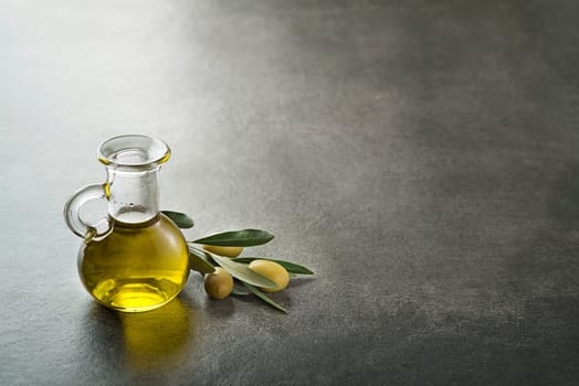 Bottle of Extra virgin healthy Olive oil with fresh olives