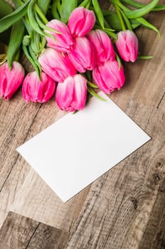 Beautiful bouquet of pink tulips and congratulations on the table