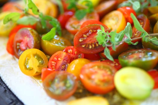 Closeup of fresh cherry tomatoes with fresh oregano