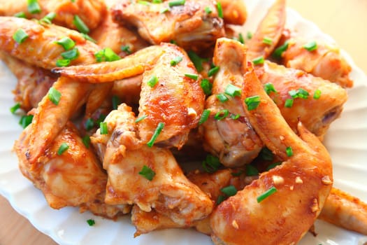 Closeup of chicken wings baked with a ketchup, soy and garlic based sauce