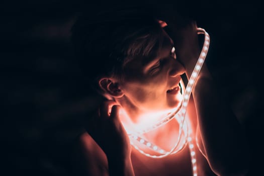 Portrait man Strip Light LED tape on dark color background.