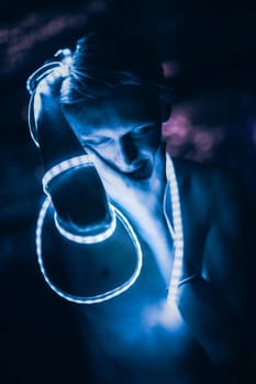Portrait man Strip Light LED tape on dark color background.