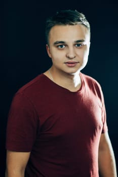 portrait of a young man on a dark background.
