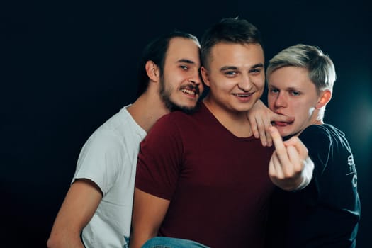 three guys are gay on dark background.