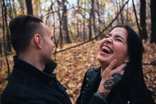 portrait of a young woman and a man walking in the autumn forest.