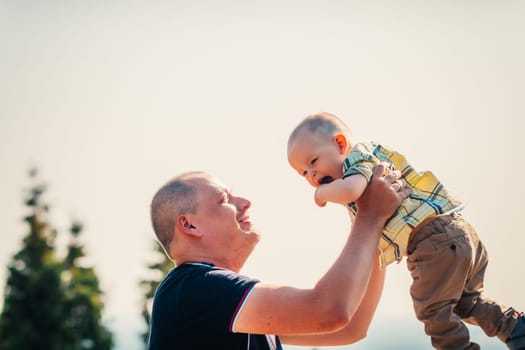 happy dad and baby on nature background.