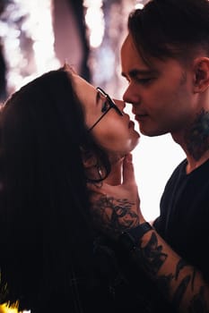 guy and the girl kiss closeup on a light background