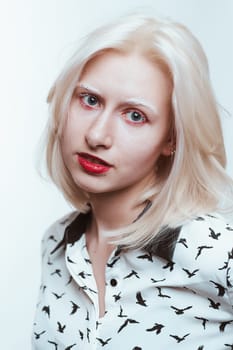 portrait blonde albino girl in studio on white background.