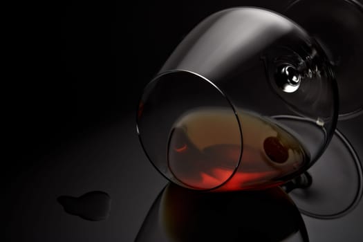 Snifter glass with cognac (brandy snifter, brandy bowl, cognac glass, or balloon) lying on a black background with reflection. Glassware for aged brown spirits. Contour with gradient and highlights