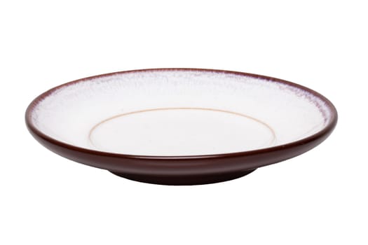 Empty plate background. A decorative brown and white  plate isolated on a white background. Kitchen ware.