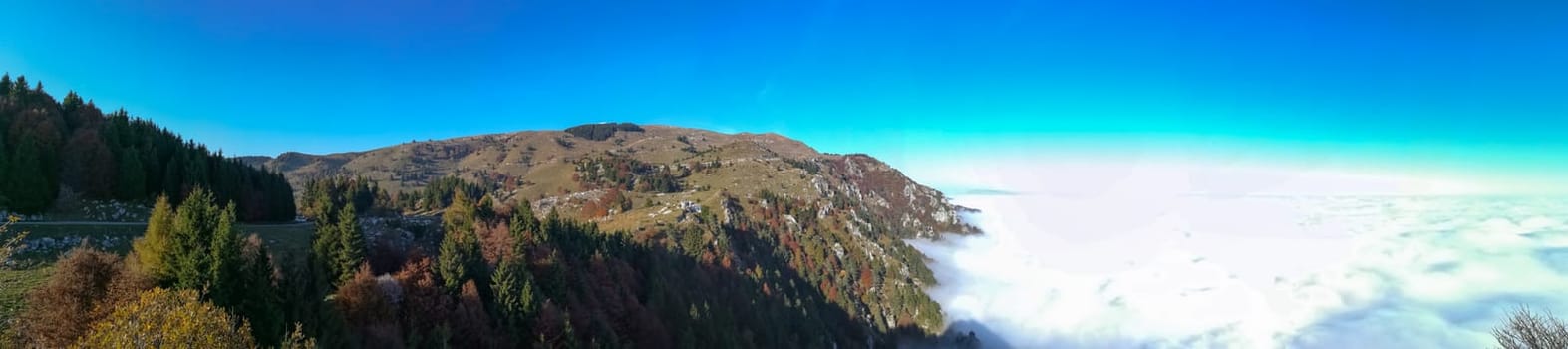 Panorama from Italian alps, carpet of clouds and peaks. Top mountain landscape