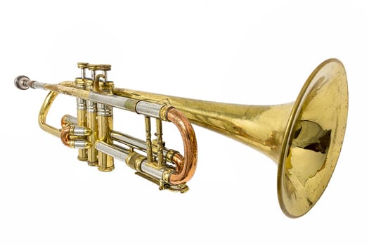 Old golden rusted trumpet with dents and scratches isolated on white