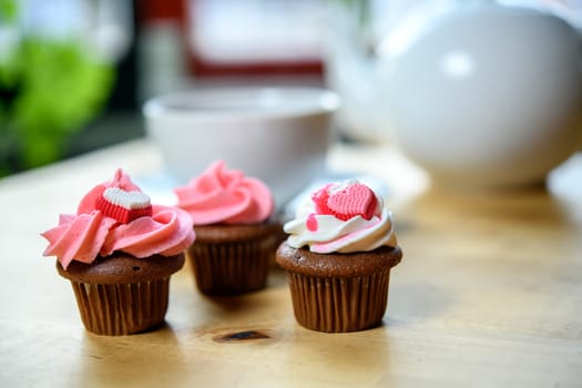 pink and white muffins  with teapot