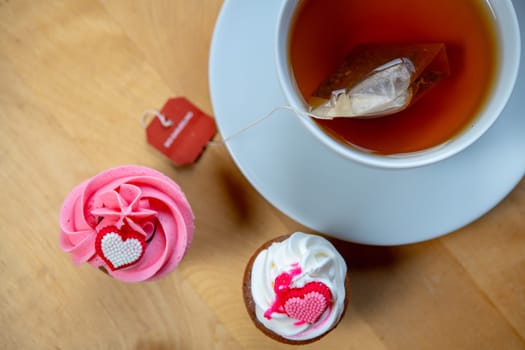 pink and white muffins  with cup of tea