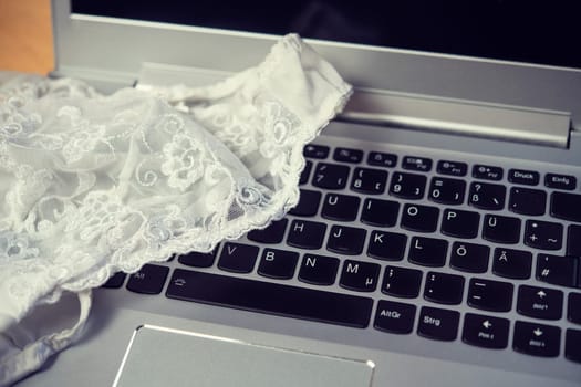 white woman panties with silver laptop- computer