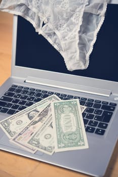 white woman panties with silver laptop- computer and money