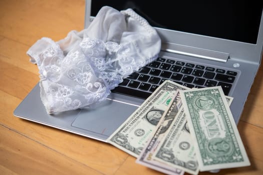 white woman panties with silver laptop- computer and money