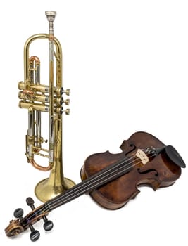 Old trumpet with scratches and dents and shiny violin isolated on white