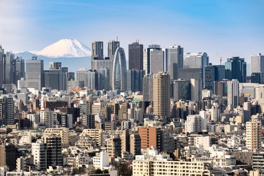 Mountain Fuji with Tokyo skylines and skyscrapers buildings in Shinjuku ward in Tokyo. Taken from Tokyo Bunkyo civic center observatory sky desk.