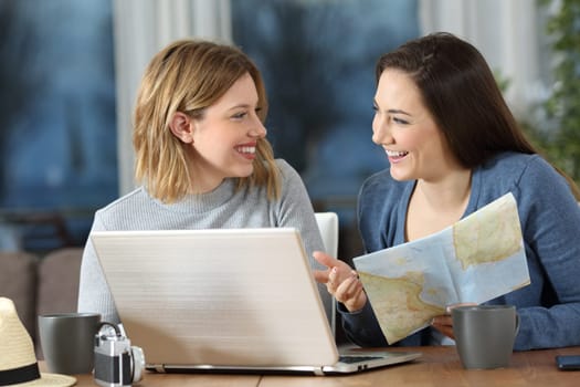 Happy friends planning travel online talking about vacation at home
