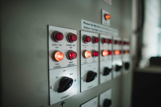 Close up shot of switches and indication lights on an electric board.