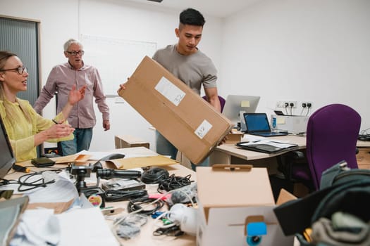Colleagues are looking stressed as they set up the office for their new business.