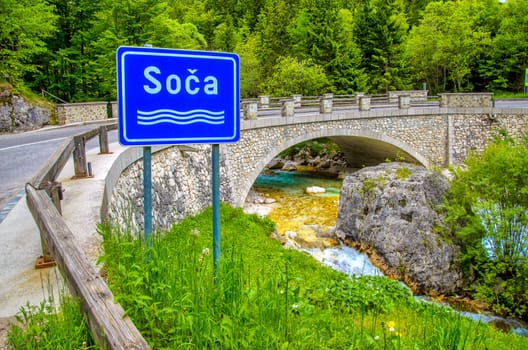 The Soca or Isonzo river sign in Slovenia - Triglav National Park .