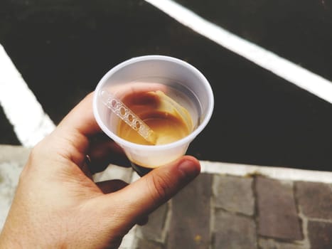 hand coffee break at work - espresso vending machine plastic cup glass .