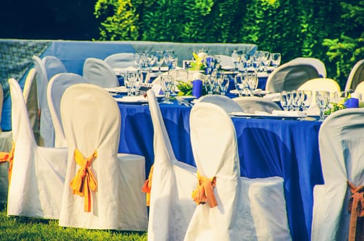 wedding chairs catering table background in garden .