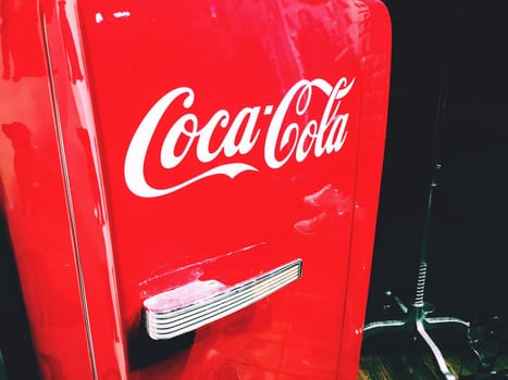Bologna, Italy, 15 Sep 2018 - a red  1950s style coke  fridge with the Coca cola logo on it