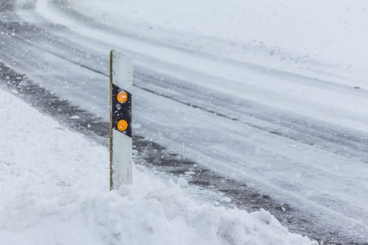 The street track is slick and frozen. High dangerous risk of an accident through the blizzard snowstorm and severe weather at christmas time season.