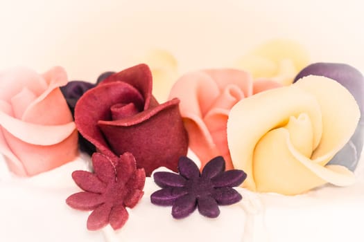A delicious YES when a man loves a woman. Wonderful macro shot of homemade marzipan torte dessert with tasty roses in pastel colors.
