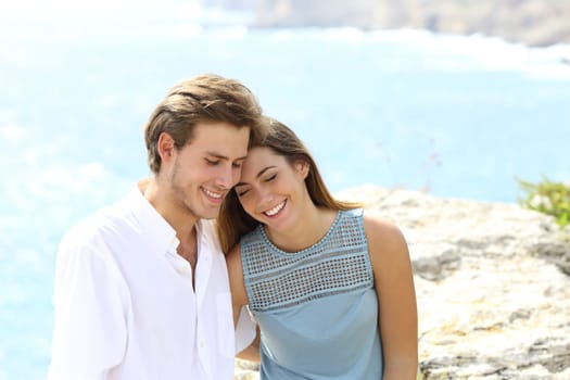Happy couple flirting on vacation travel on the beach