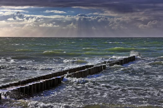 Groyne on the Baltic Sea beach near Ahrenshoop with rays of light