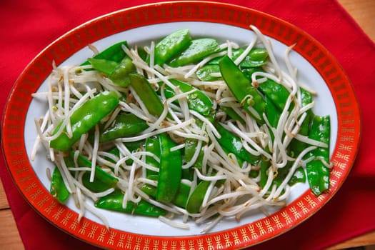 Overhead view of vegetable dish on decorative dinnerware