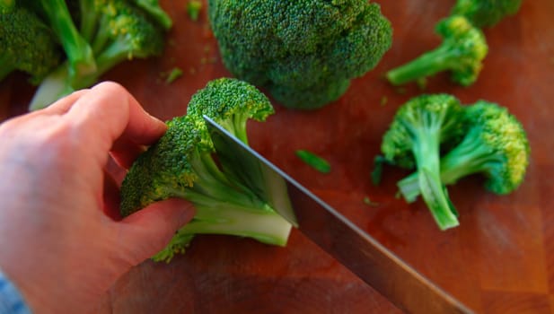 Preparing fresh broccoli on a cutting board