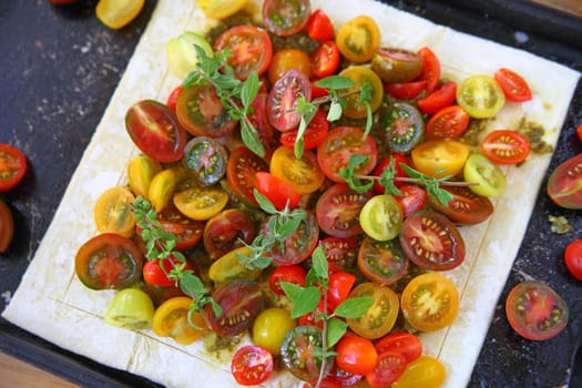 Fresh tomato tart on puff pastry ready to bake